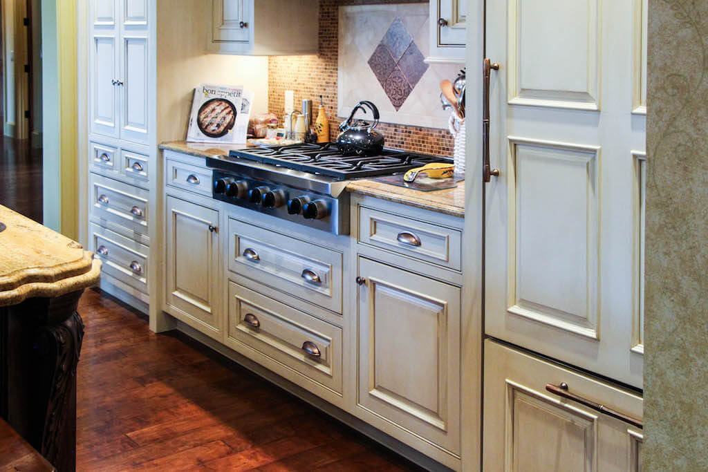 white kitchen cabinetry with copper-colored hardware
